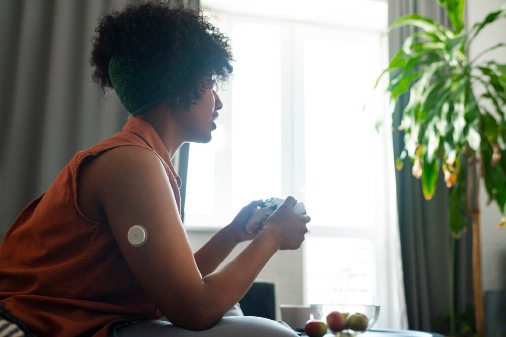 Diabetic woman wearing glucose patch sensor